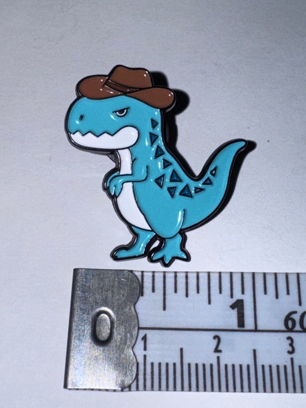 Blue dinosaur in cowboy hat pin brooch